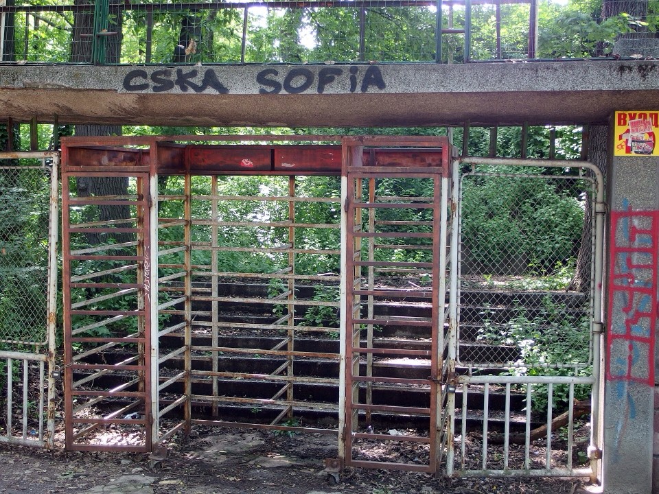 Старият стадион „Българска армия“ през 2014 г., видян отвън между дърветата на парка.